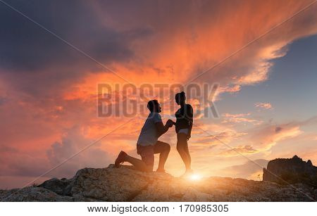 Silhouettes Of A Man Making Marriage Proposal To His Girlfriend