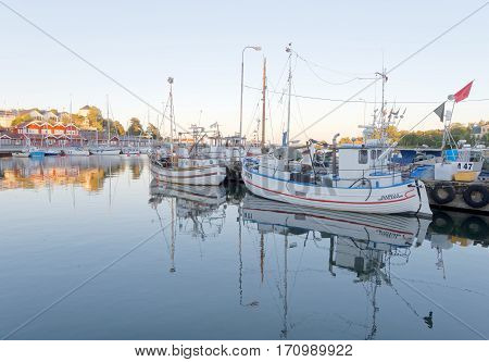 STOCKHOLM - JUL 31 2016: Many fishing boats in the rural harbor in the morning sun. July 31 2016 in Grisslehamn Sweden