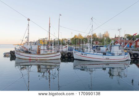 STOCKHOLM - JUL 31 2016: Many fishing boats in the rural harbor in the morning sun. July 31 2016 in Grisslehamn Sweden