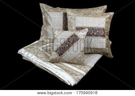 linens and pillows on a black background