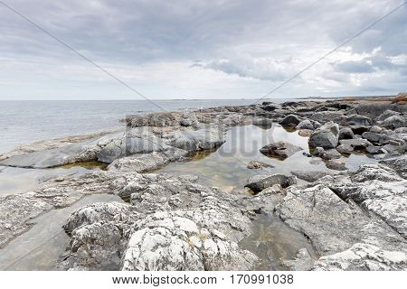 Dramatic threatening rocky coastline dark clouds and sea in the swedish archipelago
