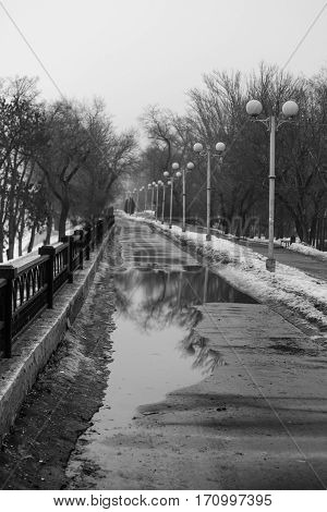 Winter city. Day. Pierce, the water in the river is frozen.