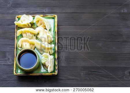 Chinese Cuisine Dish - Served Portion Of Dumplings With Three Fillings (shrimp, Egg, Greens) On Plat