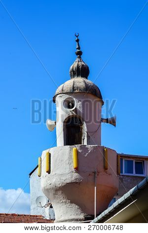 An Old Minaret Of A Small Mosque Against The Blue Sky In Istanbul