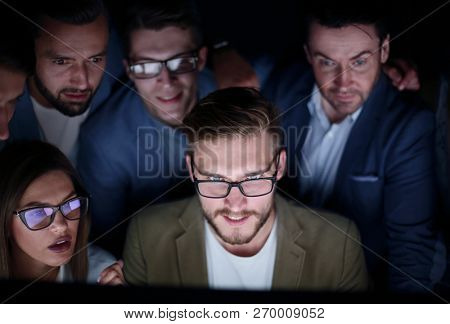 close up.a group of employees working in the office late