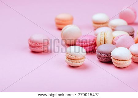 Different Types Of Macaroons On Pink Background. Sweet And Colourful French Macaroons.