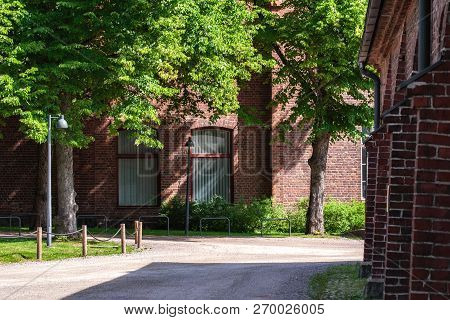Quiet, Green Inner Courtyard, Surrounded By Buildings Of Red Brick In Hyvinkaa, Finland.