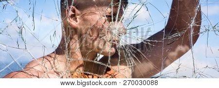 His Ambition Knows No Bounds. Strong Man Seen Through Cracked Glass. Sport Man With Muscular Strengt