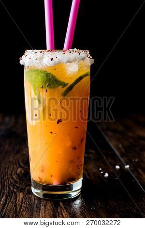 Mexican Michelada Cocktail With Beer, Lime, Ice And Spices..