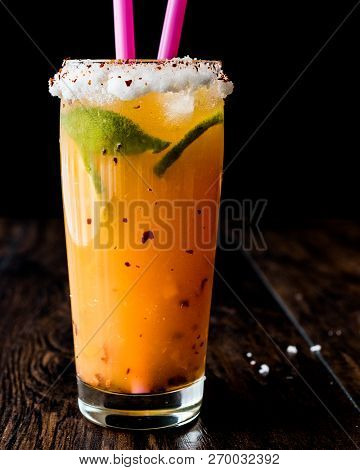 Mexican Michelada Cocktail With Beer, Lime, Ice And Spices..