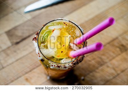 Mexican Michelada Cocktail With Beer, Lime, Ice And Spices..