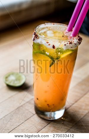 Mexican Michelada Cocktail With Beer, Lime, Ice And Spices..