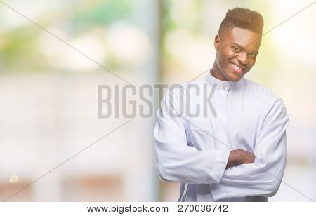 Young arabic african man wearing traditional djellaba over isolated background happy face smiling with crossed arms looking at the camera. Positive person.