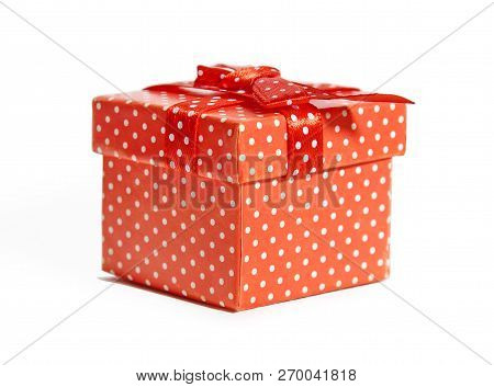 Gift Red Box In White Polka Dots With Bow Isolated On White Background Close-up