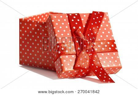 Gift Red Box In White Polka Dots With Bow Isolated On White Background Close-up