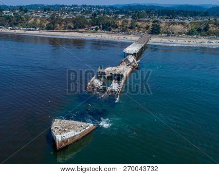 An Aerial Shot Of A Cement Ship Beached On The Coast Of California