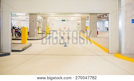Light Interior Of Underground Parking. Yellow Elements  And Blue Lanes.