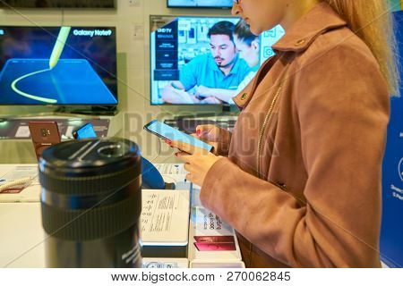 MOSCOS, RUSSIA - SEPTEMBER 20, 2018: woman hold smartphone at Samsung store in Moscow.