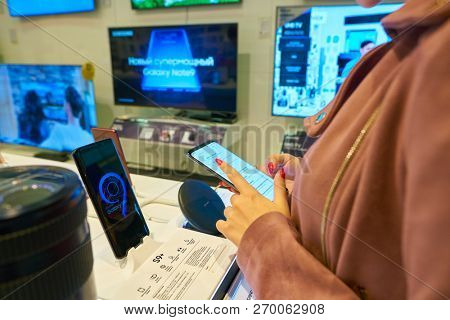 MOSCOS, RUSSIA - SEPTEMBER 20, 2018: woman hold smartphone at Samsung store in Moscow.