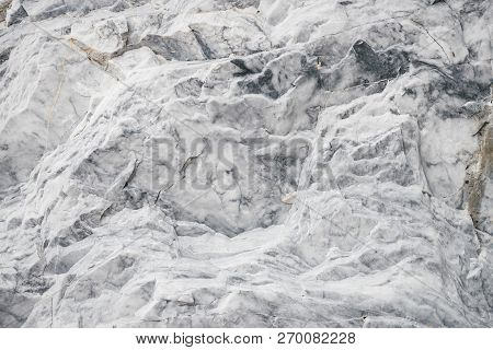 Marble In Natural Form. Texture Of Marble Rock Close Up. Background Image Of Beautiful Stone. Many S