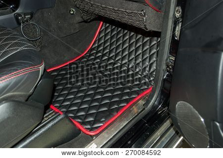 A View Of A Part Of The Interior Of The Car Dashboard From Leather Of Black Color, Stitched Double T