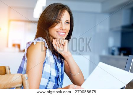 Woman with papers in their living room