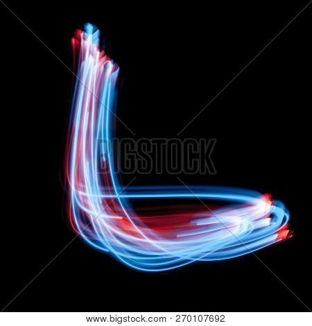 Letter L Of The Alphabet Made From Neon Sign. The Blue Light Image, Long Exposure With Colored Fairy