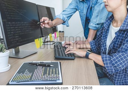 Writing Codes And Typing Data Code Technology, Two Professional Programmer Cooperating Working On We