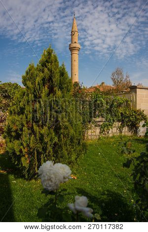 Cappadocia, Turkey: Mosque Minaret On The Background Of White Rose Flowers