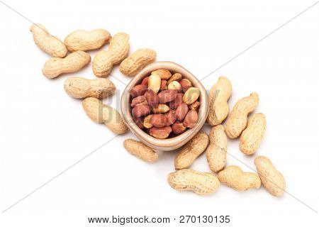 Roasted peanuts with peanut shells isolated on white background