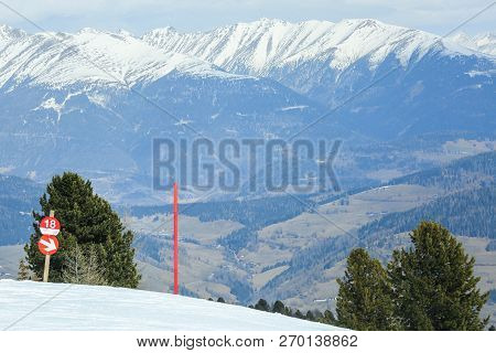 Red Post Sign Marking The Edge Of Ski Slope
