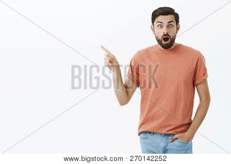Guy Shocked Watching Amazing Show. Portrait Of Impressed And Speechless Astonished Handsome 30s Male