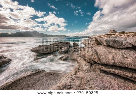 Dramatic Long Exposure Image Of Waves Washing Onto Rocks On The Coast By The Genoese Tower At Punta 