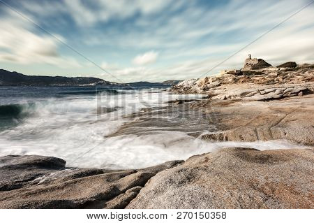 Long Exposure Image Of Waves Washing Onto Rocks On The Coast By The Genoese Tower At Punta Caldanu N