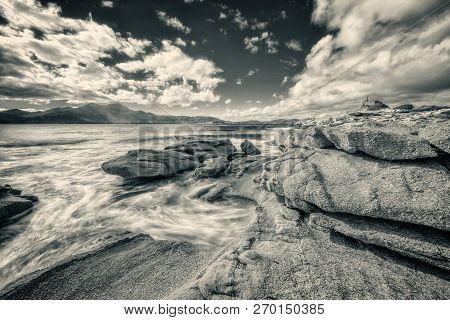 Dramatic Black & White Long Exposure Image Of Waves Washing Onto Rocks On The Coast By The Genoese T