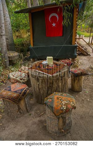 Unusual Tables And Chairs Made Of Hemp, On Top Of Traditional Cape Carpets With A Pattern. Cappadoci
