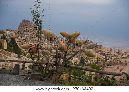 Cappadocia, Turkish: Tree With Pots On The Hill, In The Distance Is The City Of Uchisar