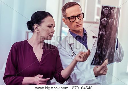 Concentrated Medical Worker Listening To His Patient