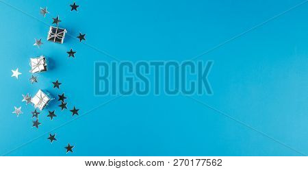 Christmas Decoration On The Christmas Tree In The Form Of Small Silver Gift Boxes And Silver Stars O