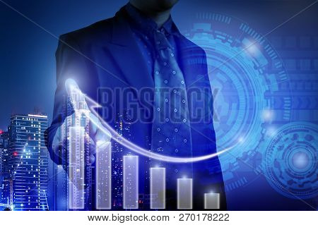 Business Man Pointing At White Bar Chart For Business Growth Concept And  Inspects Graphs Seen Throu