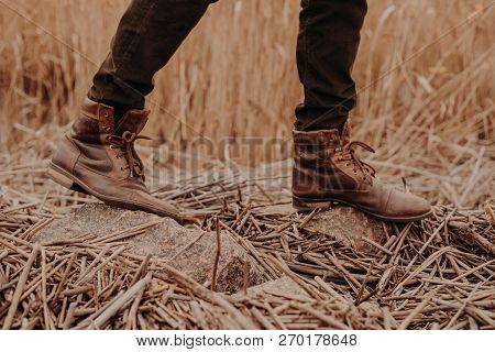 Mens Brown Shoes In Rural Territory. Unrecognizable Masculine In Trouses And Boots. Leather Old Foot