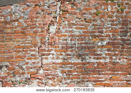 Old Cracked And Damaged Brick Wall (italy)