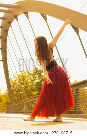 Young Slim Woman With Long Brown Hair Dancing