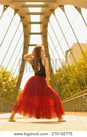 Young Slim Woman With Long Brown Hair Dancing