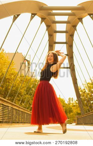Young Slim Woman With Long Brown Hair Dancing