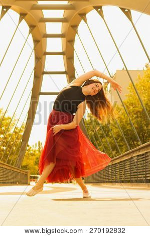 Young Slim Woman With Long Brown Hair Dancing