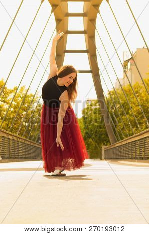 Young Slim Woman With Long Brown Hair Dancing