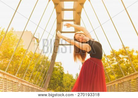 Young Slim Woman With Long Brown Hair Dancing