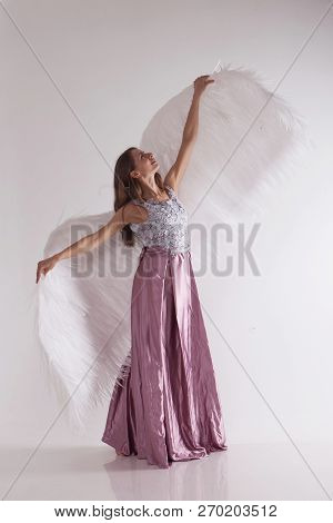Girl In Pink Dress With Angel Wings On White Background. Angel-woman