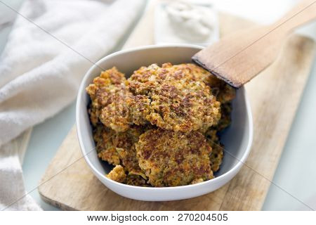 Pancakes Of Carrots And Apples In A Plate, Wooden Kitchen Spatula, Vegetable Pancakes On A Wooden Bo